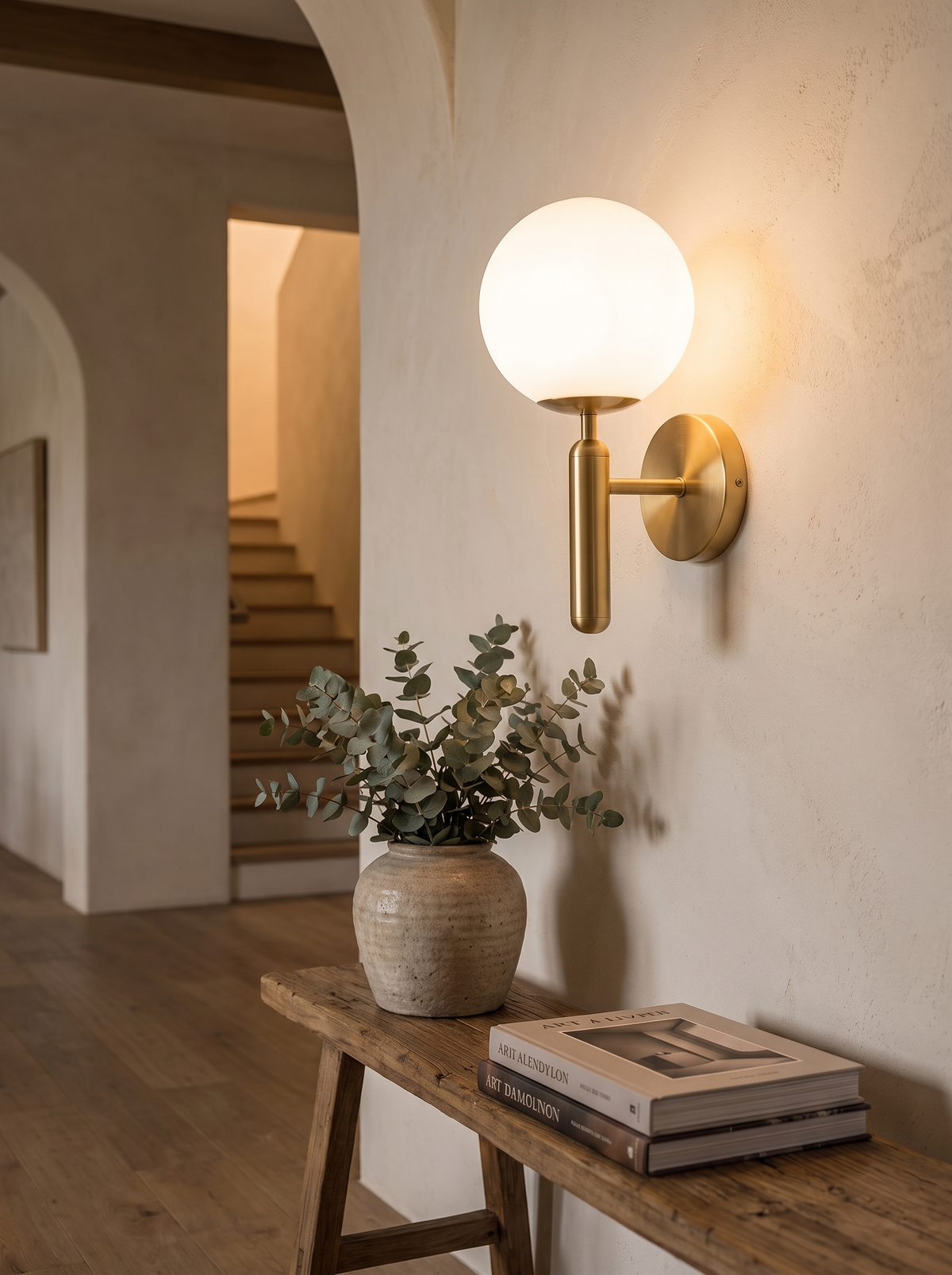 Quill Indoor Wall Light glowing in a hallway above a timber console